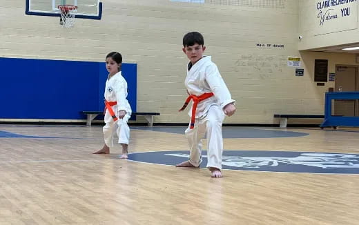 a couple of boys in karate uniforms