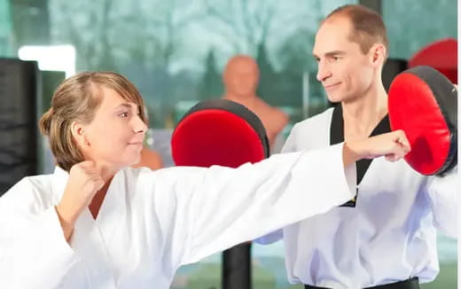 a man and a woman holding a boxing ring