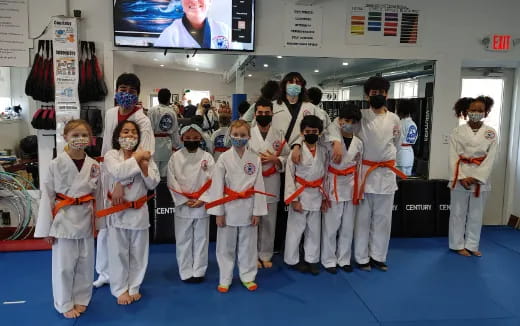 a group of kids in karate uniforms