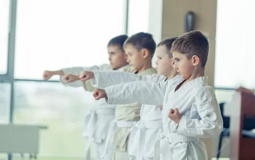 a group of children in white uniforms