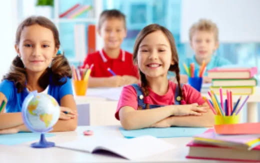 a group of children sitting at a table