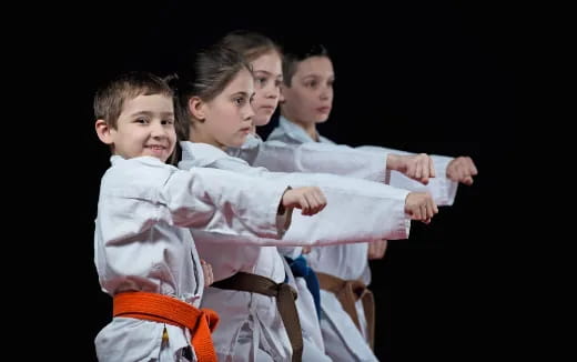 a group of boys in karate uniforms