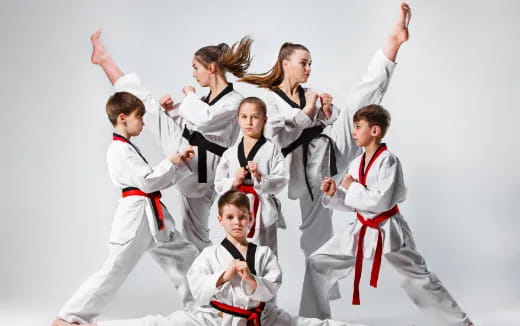 a group of people in karate uniforms