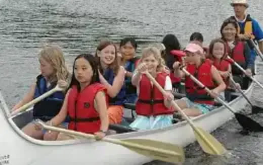 a group of people rowing a boat