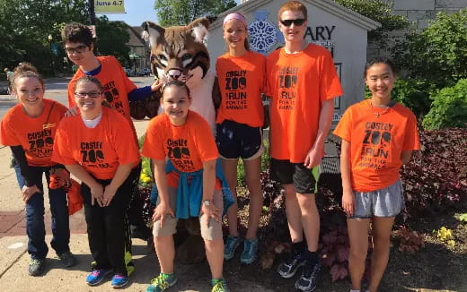 a group of people wearing orange shirts