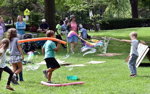 a group of people playing with a toy