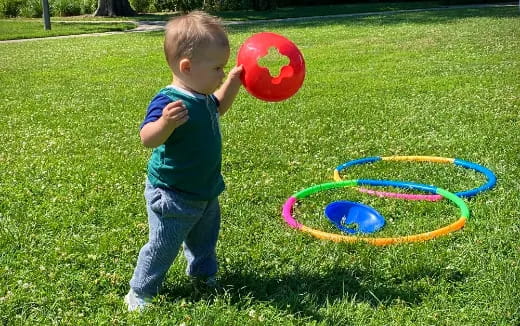 a baby playing with a ball
