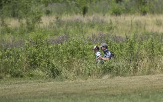 a couple of men in a field