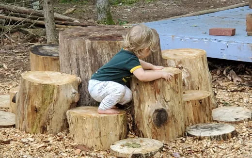 a child playing with a wooden structure