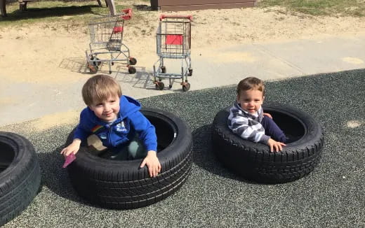 two kids playing in a sandbox