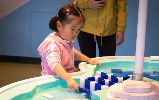 a young girl playing with a toy