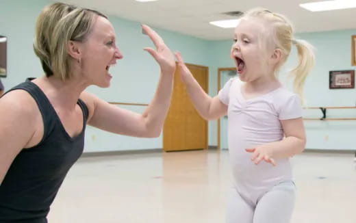 a woman and a child dancing