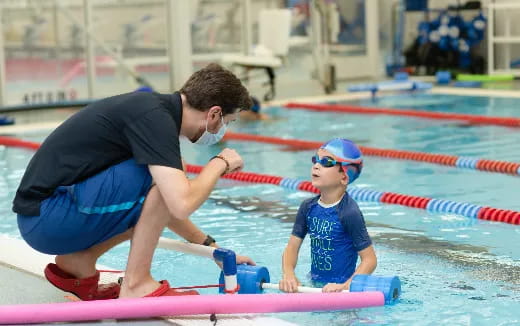 a person and a child in a pool
