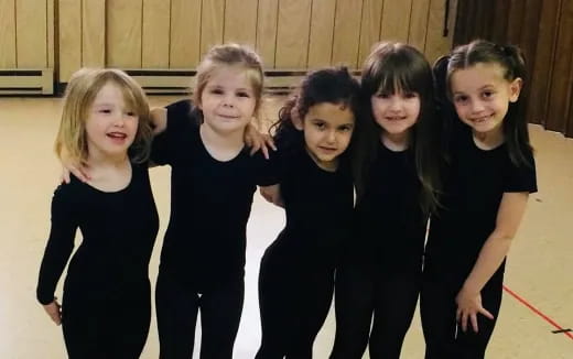 a group of girls in black
