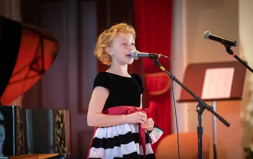 a person singing into a microphone