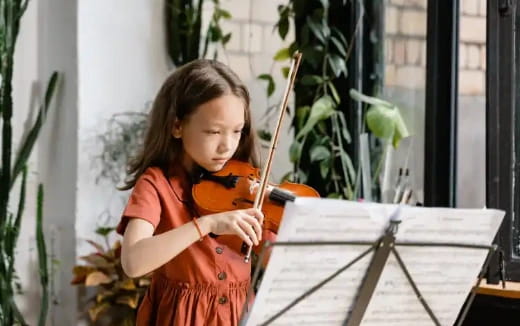 a little girl holding a toy gun
