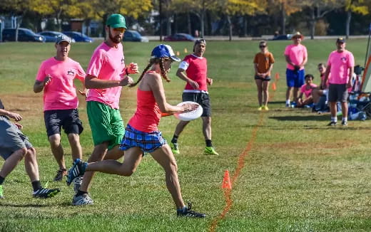 a group of people playing frisbee