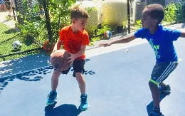 a couple of boys playing in a pool