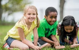 a group of children sitting on the ground