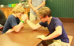 a couple of boys sitting at a table