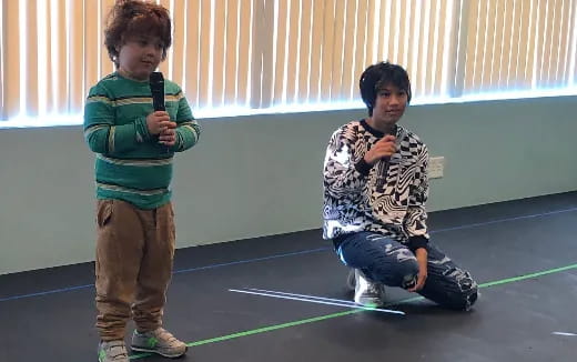 two boys holding a bow and arrow