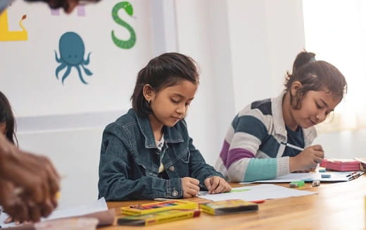 a few women studying in a classroom