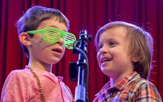 a couple of children with green glasses