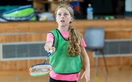 a girl holding a tennis racket