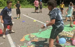a group of children playing with a rope