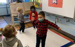 a group of children playing with a toy