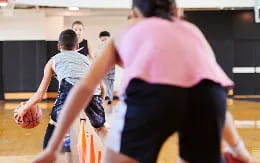 a group of people playing basketball