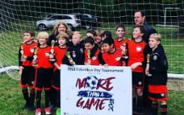 a group of kids holding trophies
