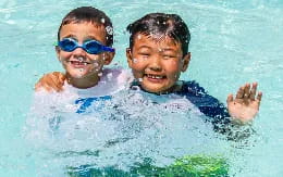 a couple of boys in a pool