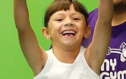 a boy with his arms raised