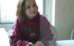 a girl sitting at a table
