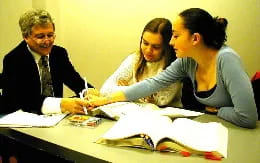 a group of people looking at a paper