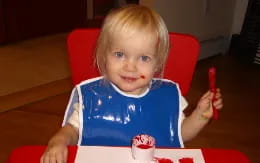 a baby sitting at a table