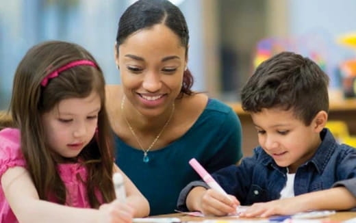 a person and children looking at a book