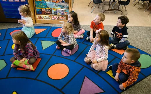 a group of children sitting on the floor