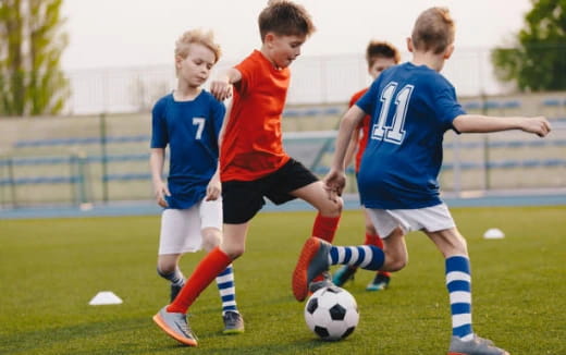 a group of kids playing football