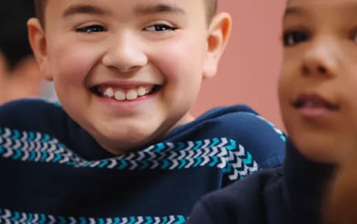 a close-up of a boy smiling