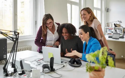a group of people looking at a computer screen
