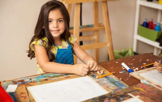 a girl sitting at a table