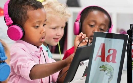 a group of children looking at a computer screen