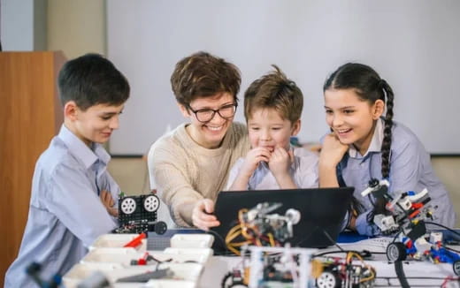 a group of people looking at a computer
