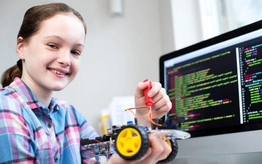 a young girl using a computer