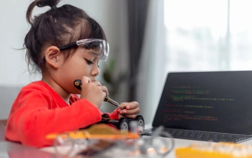 a young girl using a laptop
