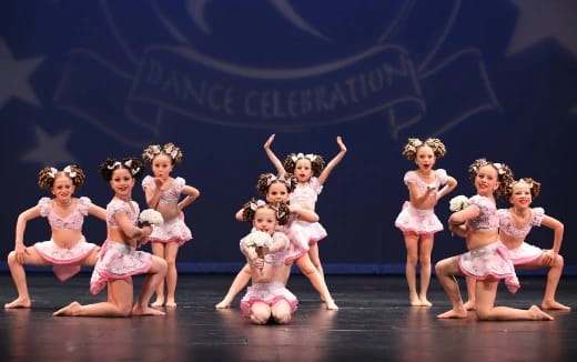 a group of girls in ballet outfits