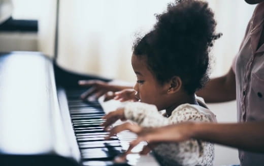 a baby playing a piano