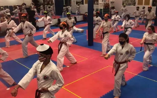 a group of people in a karate class